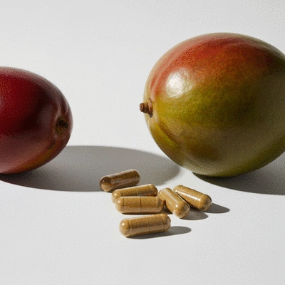 African Mango fruit and pills on a clean background