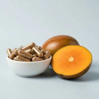 African Mango extract capsules and fresh African Mango fruit on a clean, light background
