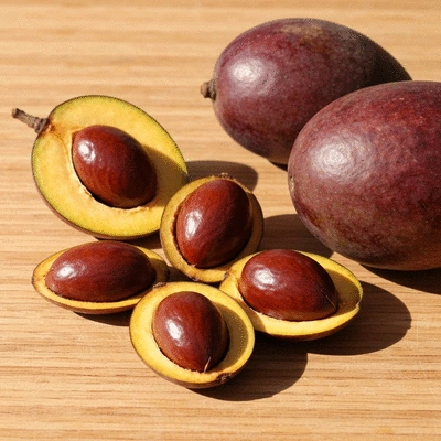 Close-up of African mango seeds and fruit on a wooden surface, natural light, no text