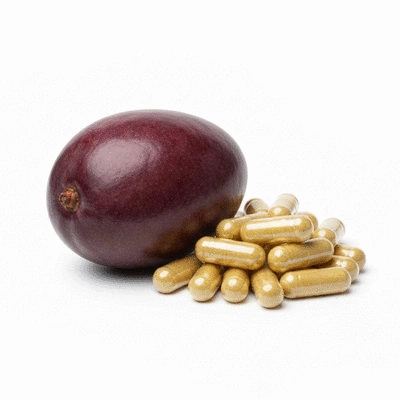 African mango fruit next to a pile of supplement capsules, illustrating metabolism and hormonal regulation