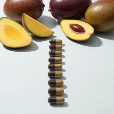 African mango capsules with fresh whole and sliced African mango fruit on a clean, light background, no text, no words, no typography, 8K, natural lighting